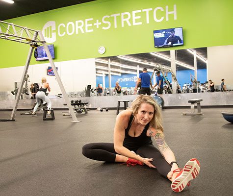 woman stretching in core stretch area at gym in tulsa