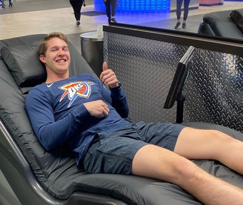 person using the hydromassage chair in Oklahoma gym