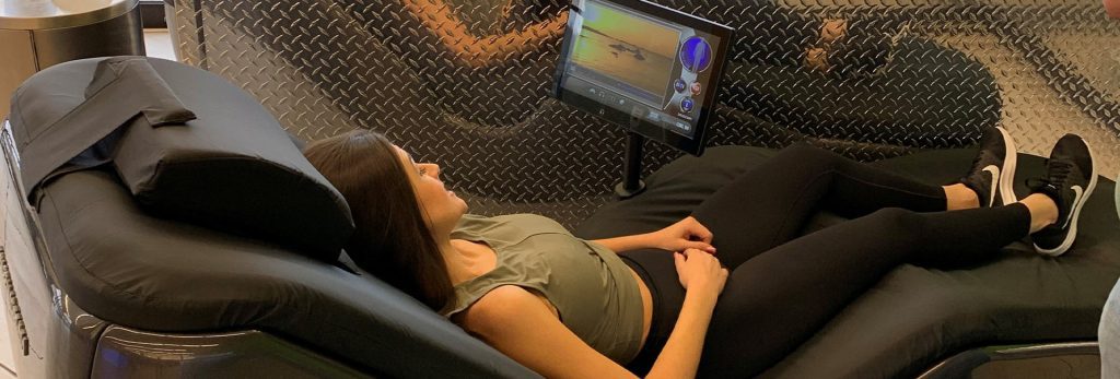 woman using hydromassage chair to recover after workout