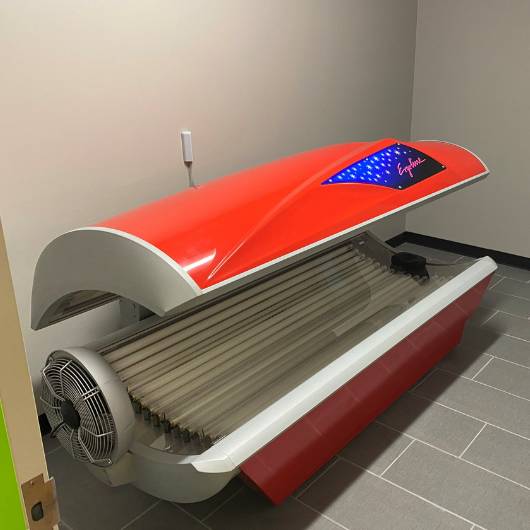 a modern tanning bed at 10GYM Jenks, providing a safe and effective tanning experience