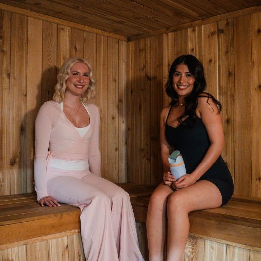 Members relaxing in the wood sauna recovery room at 10GYM Jenks.