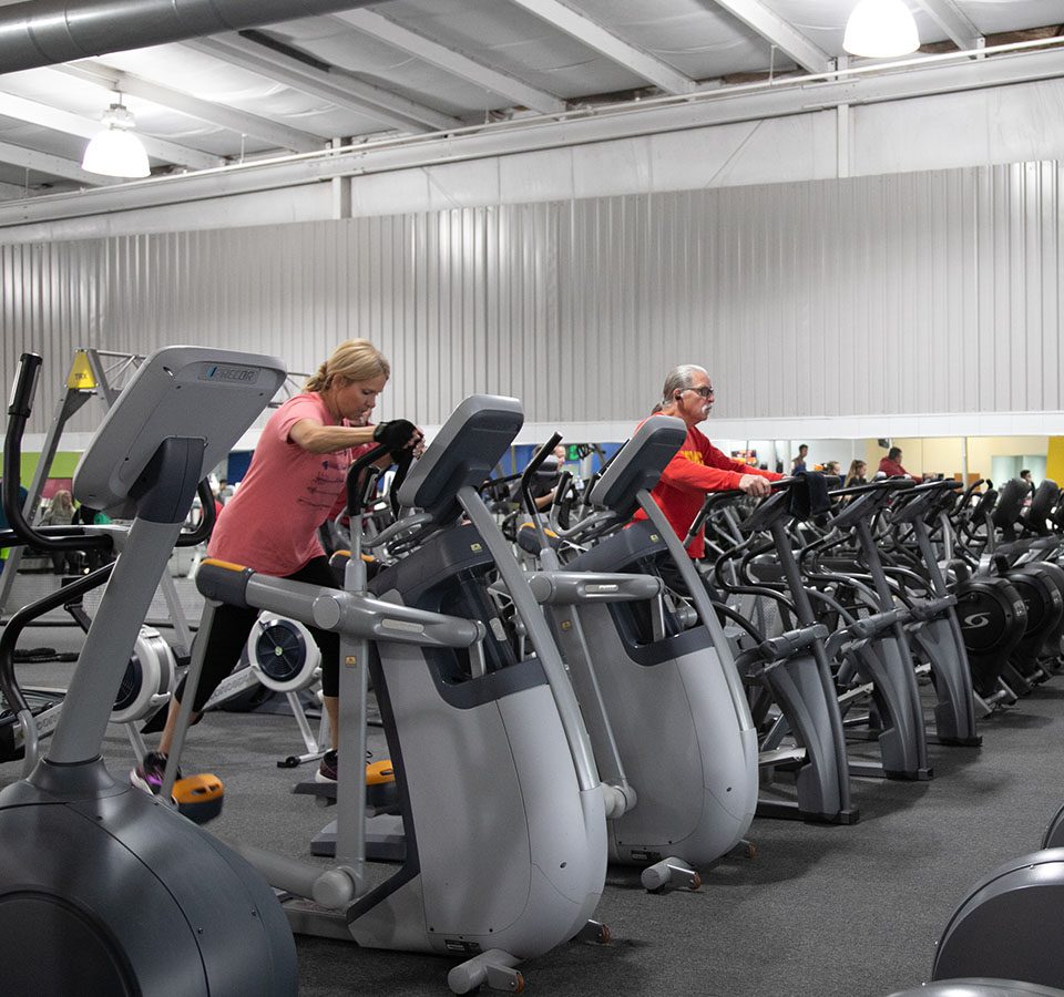 gym members using cardio machines in spacious cardio floor