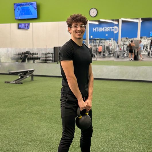 a gym member uses a kettlebell for functional training workout at 10gym's owasso location near me