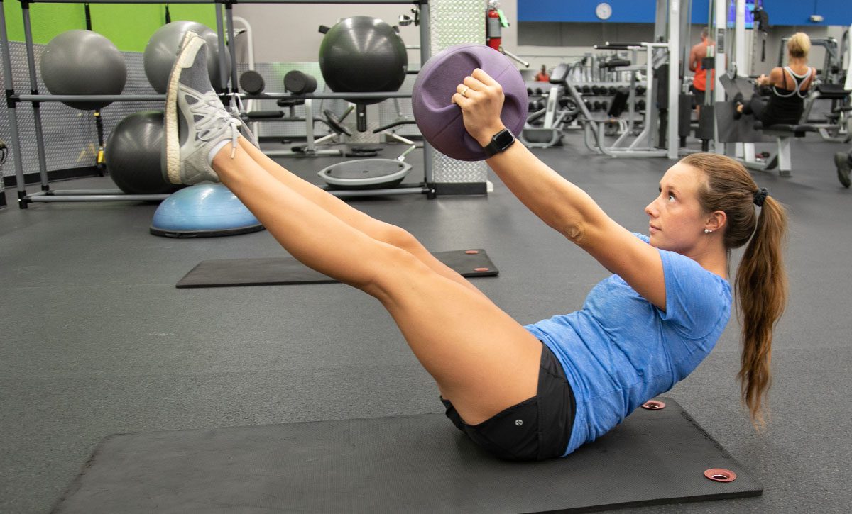 Woman working out her abs with a ball