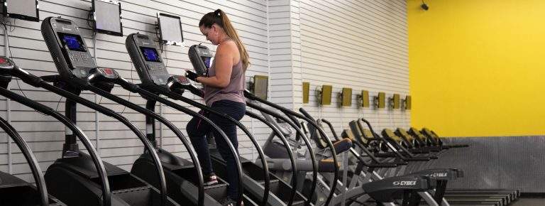 Woman using a cardio machine in 10 Gym.