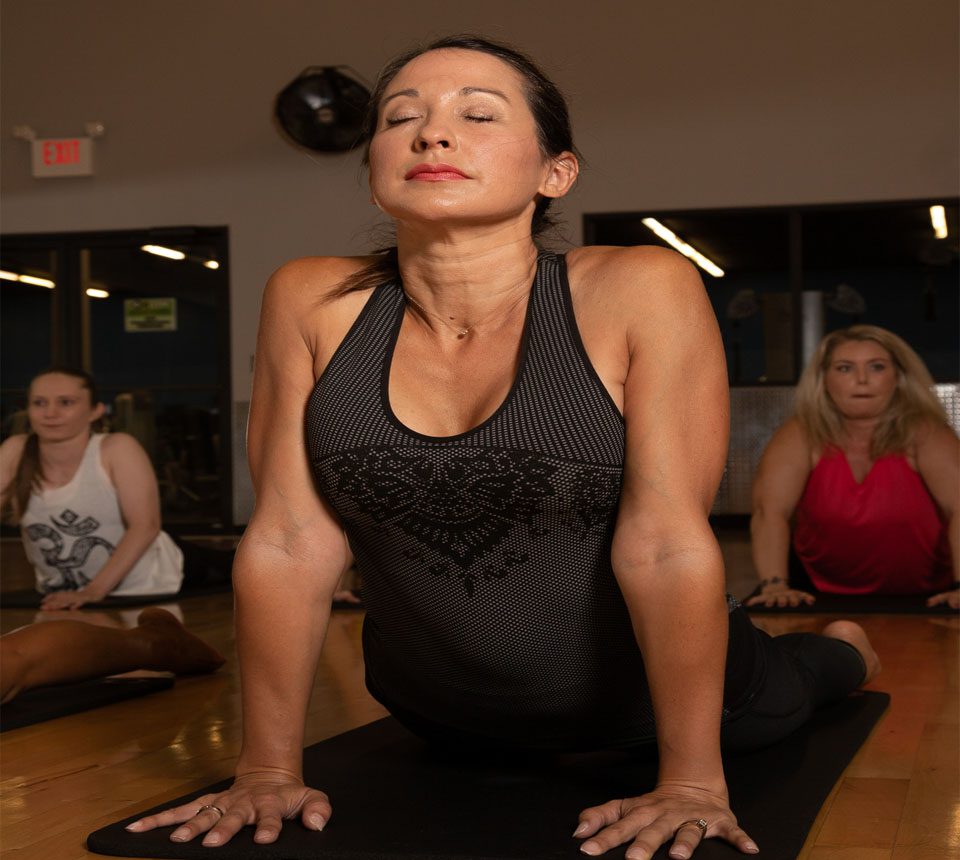 woman doing a yoga pose in a group class