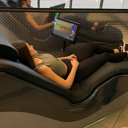 woman using hydromassage chair to recover after workout