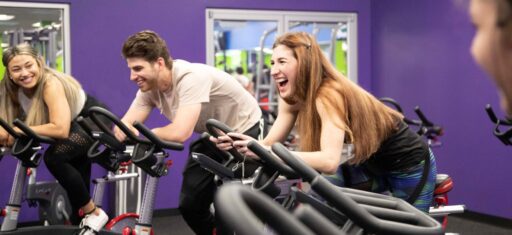 gym members ride stationary bikes during a spinning group fitness class at 10gym in oklahoma